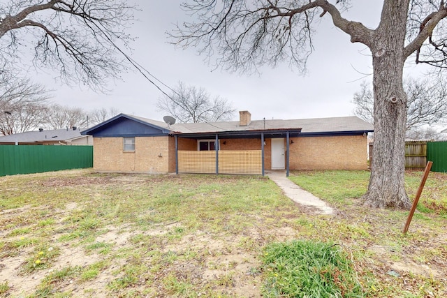 rear view of property with a yard