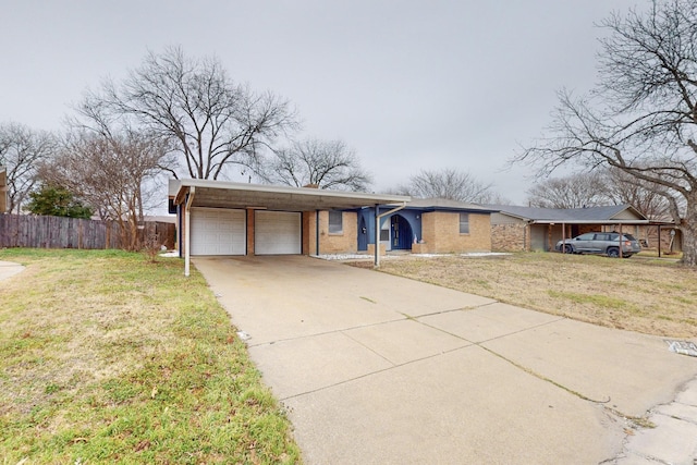 ranch-style home featuring a garage and a front yard