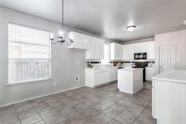 4201 Broken Bend Blvd, Fort Worth, TX 76244 - kitchen with black microwave, a chandelier, light countertops, a kitchen island, and electric range