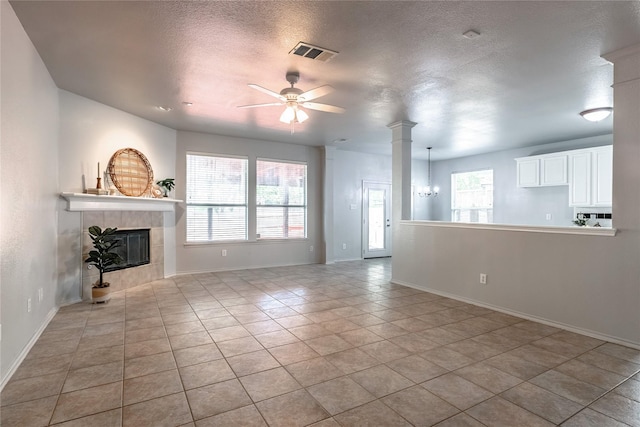 4201 Broken Bend Blvd, Fort Worth, TX 76244 - unfurnished living room featuring a fireplace, a ceiling fan, plenty of natural light, a chandelier, and a textured ceiling