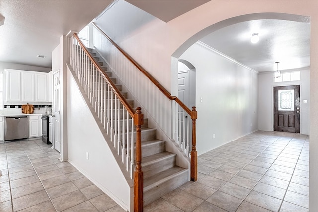 4201 Broken Bend Blvd, Fort Worth, TX 76244 - entrance foyer with light tile patterned flooring, stairway, ornamental molding, and arched walkways