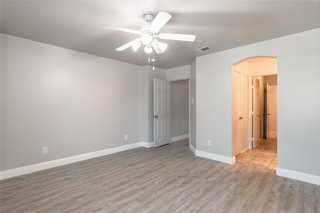 4201 Broken Bend Blvd, Fort Worth, TX 76244 - unfurnished bedroom featuring arched walkways, light wood-style floors, and a ceiling fan