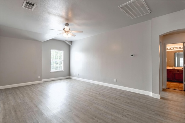 4201 Broken Bend Blvd, Fort Worth, TX 76244 - spare room with arched walkways, a ceiling fan, and wood finished floors