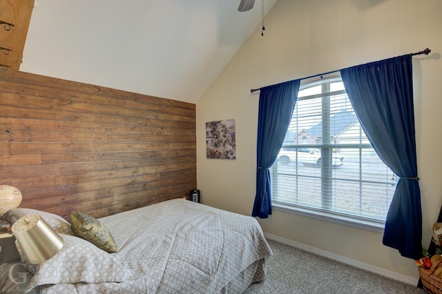 bedroom featuring ceiling fan, high vaulted ceiling, carpet, and wood walls