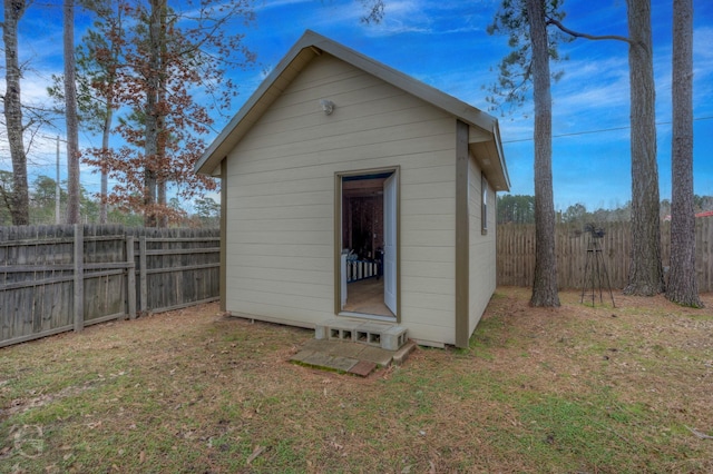 view of outbuilding featuring a lawn