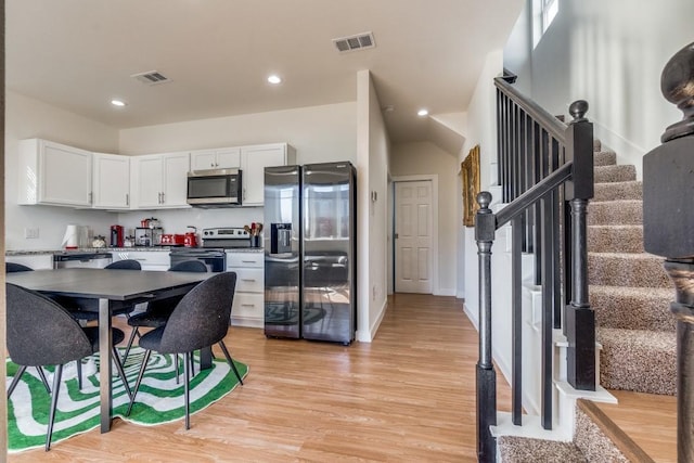 kitchen featuring light hardwood / wood-style floors, white cabinets, and appliances with stainless steel finishes