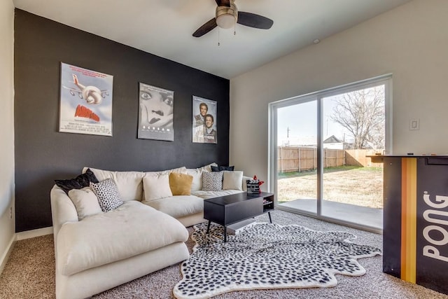 carpeted living room with ceiling fan