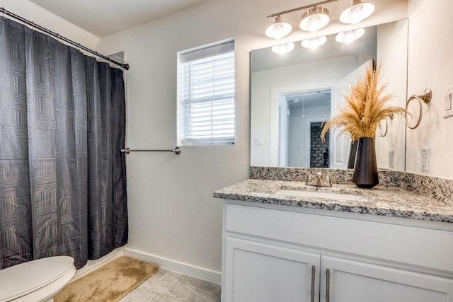 bathroom with vanity, a shower with curtain, and toilet