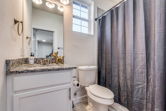 bathroom featuring vanity, toilet, and a shower with shower curtain