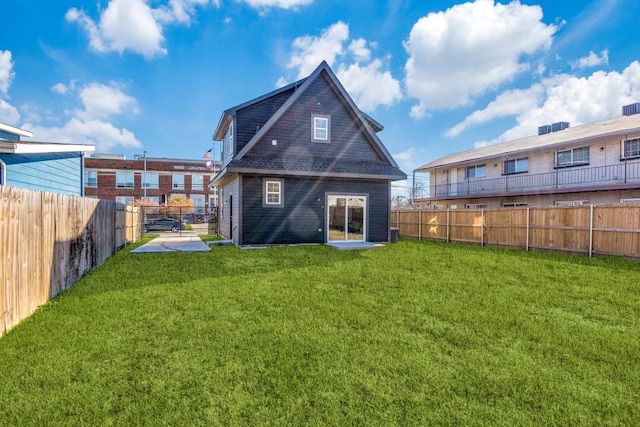 rear view of property with a lawn