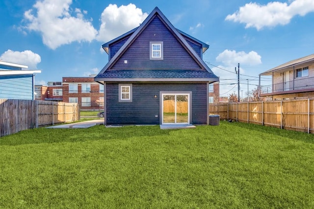 back of property featuring cooling unit and a lawn