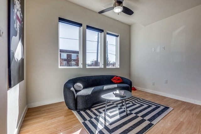 living area featuring ceiling fan and hardwood / wood-style floors