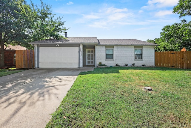 ranch-style house featuring a garage and a front lawn