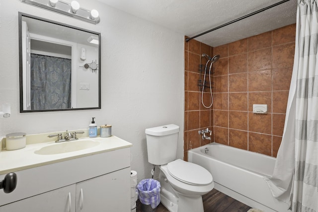 full bathroom featuring hardwood / wood-style flooring, vanity, toilet, shower / bath combo, and a textured ceiling