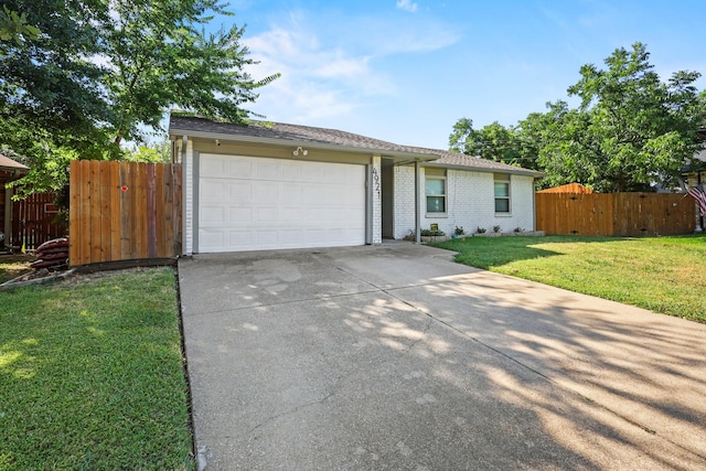 ranch-style home featuring a garage and a front yard