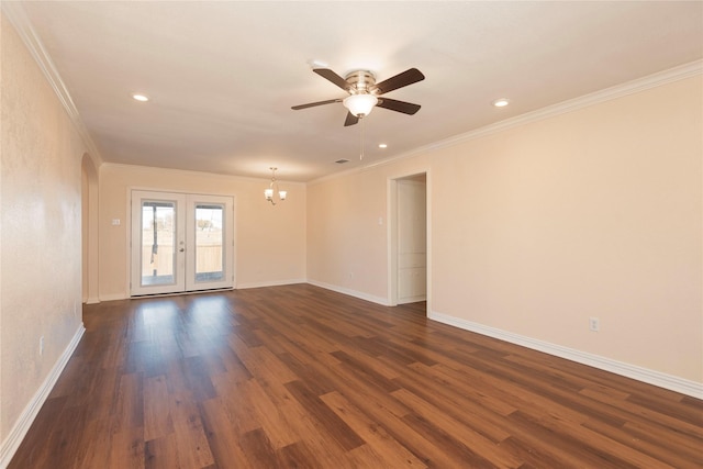 spare room with crown molding, dark hardwood / wood-style floors, ceiling fan with notable chandelier, and french doors