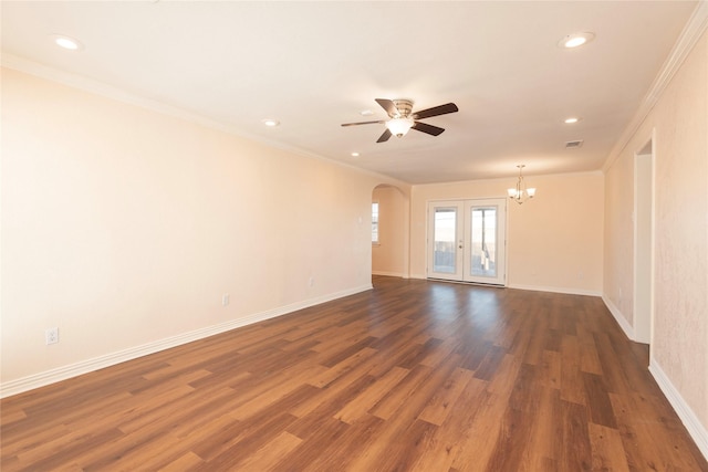 spare room with ceiling fan with notable chandelier, ornamental molding, dark hardwood / wood-style floors, and french doors