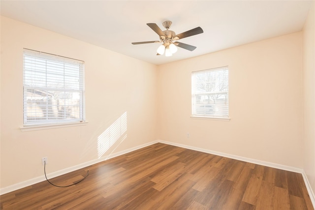 empty room featuring dark wood-type flooring and ceiling fan