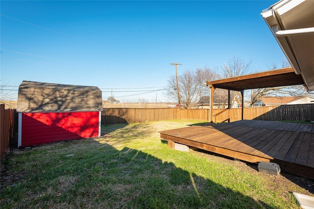 view of yard featuring a storage shed and a wooden deck