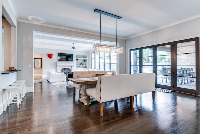 dining space with french doors, ornamental molding, dark hardwood / wood-style flooring, and built in features