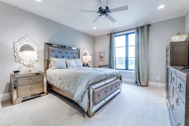 carpeted bedroom with ceiling fan and ornamental molding