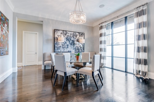 dining room with crown molding, dark hardwood / wood-style floors, and a chandelier