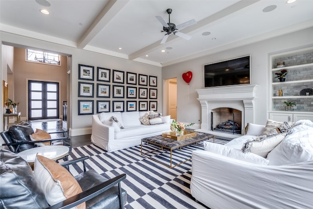 living room featuring ceiling fan, built in features, beam ceiling, and french doors