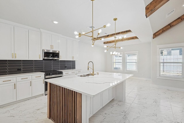 kitchen featuring sink, appliances with stainless steel finishes, an island with sink, pendant lighting, and white cabinets