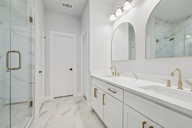 bathroom with vanity and a shower with door