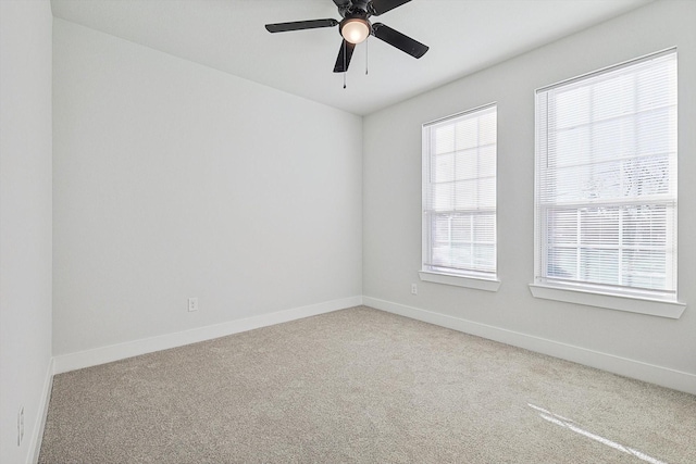 carpeted spare room with ceiling fan