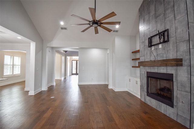 unfurnished living room with a tile fireplace, high vaulted ceiling, dark wood-type flooring, and ceiling fan