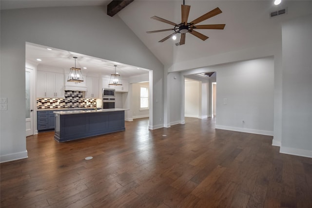 unfurnished living room featuring sink, ceiling fan, beam ceiling, high vaulted ceiling, and dark hardwood / wood-style floors