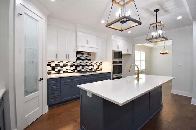 kitchen featuring sink, white cabinetry, an island with sink, pendant lighting, and stainless steel appliances