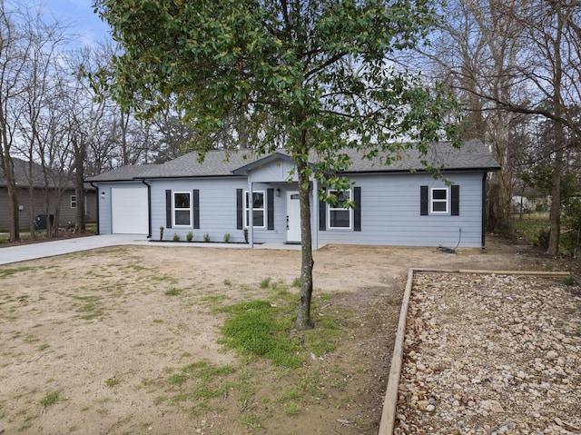 ranch-style house featuring concrete driveway and an attached garage