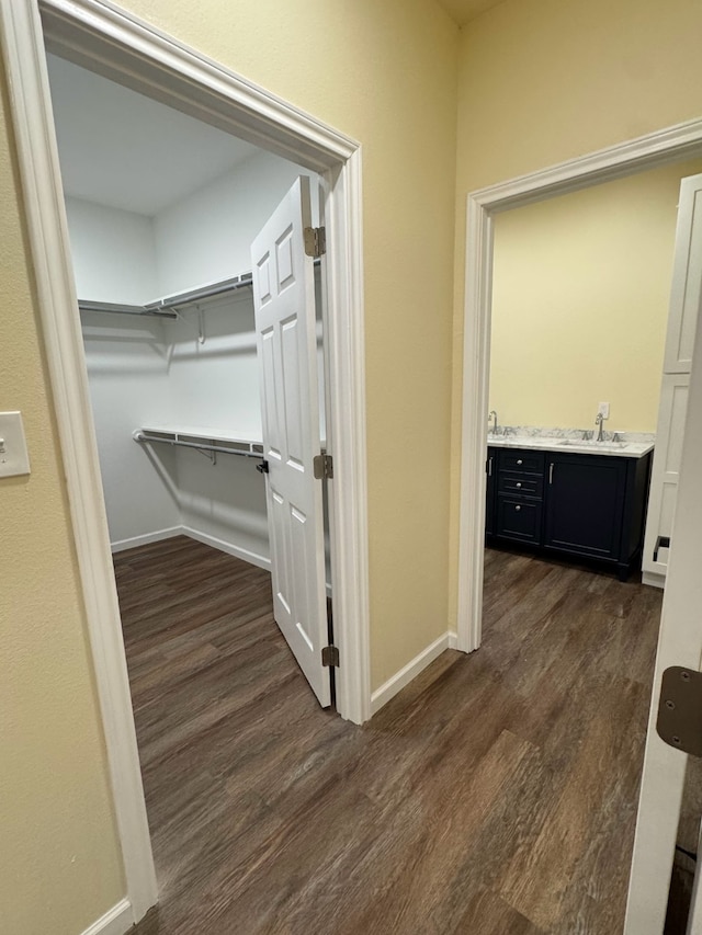 hall featuring dark hardwood / wood-style flooring and sink