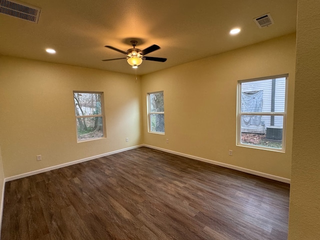 spare room with dark hardwood / wood-style flooring and ceiling fan