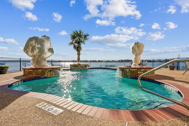 view of swimming pool featuring pool water feature and a water view