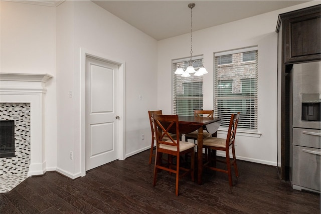 dining space featuring an inviting chandelier and dark hardwood / wood-style flooring