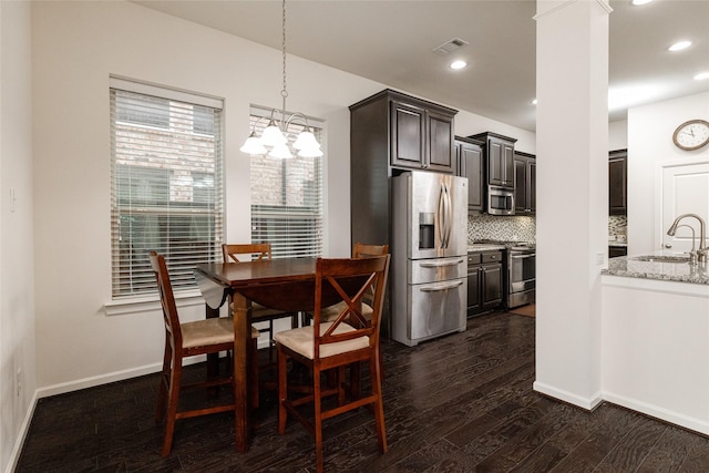 dining space with sink and dark hardwood / wood-style floors