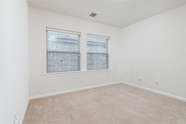 empty room featuring light carpet