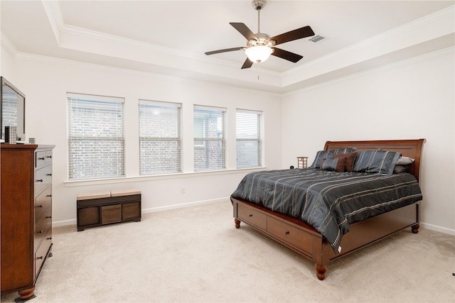 bedroom featuring crown molding, light carpet, ceiling fan, and a tray ceiling