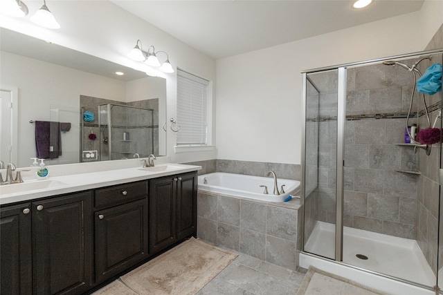 bathroom featuring vanity and independent shower and bath