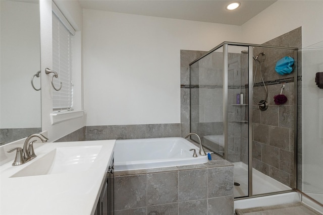 bathroom featuring independent shower and bath and vanity