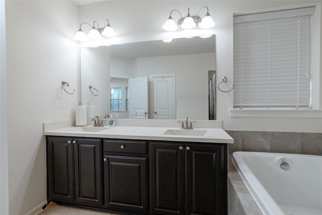 bathroom with vanity and a relaxing tiled tub