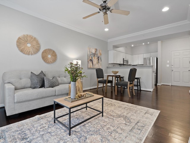 living room with ceiling fan, ornamental molding, and dark hardwood / wood-style flooring