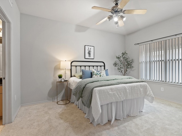 bedroom featuring light carpet and ceiling fan