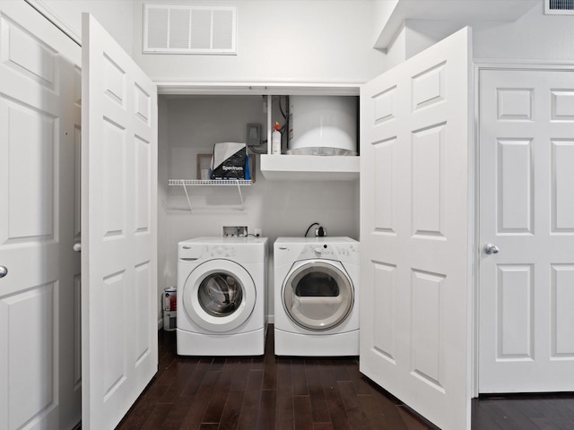 washroom featuring washing machine and clothes dryer and dark hardwood / wood-style floors