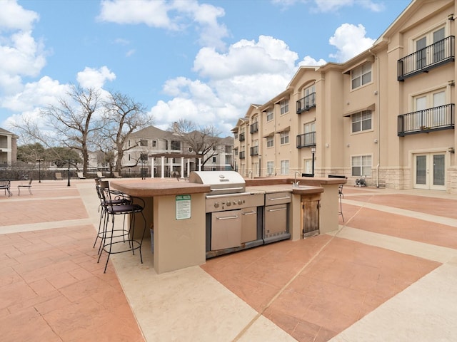 view of patio with a bar and area for grilling