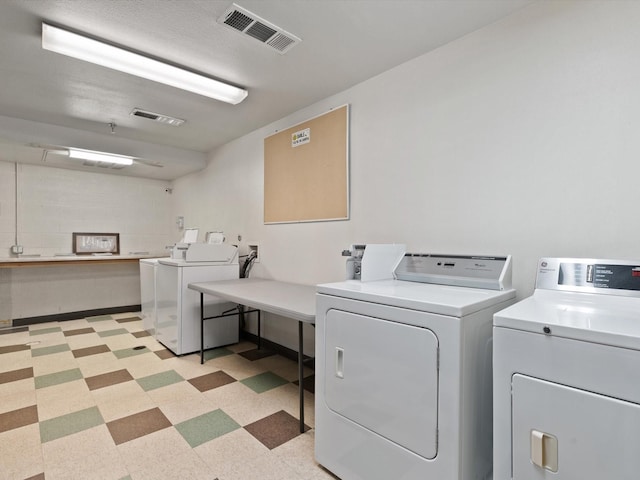 clothes washing area featuring separate washer and dryer