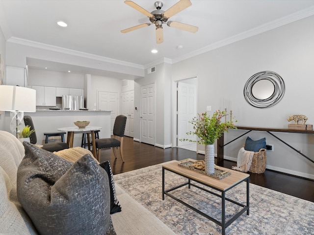 living room with crown molding, dark wood-type flooring, and ceiling fan